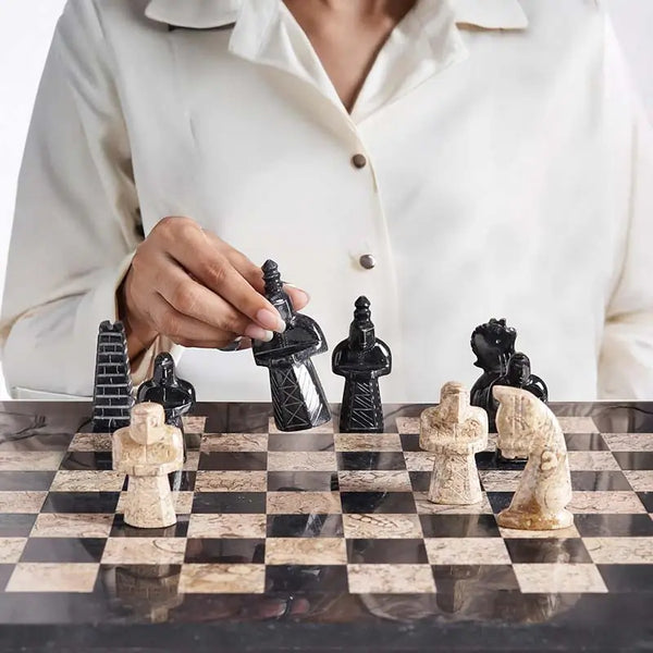 Hand moving black marble rook tower piece — black and coral antique medieval figurative chess pieces close-up by RADICALn