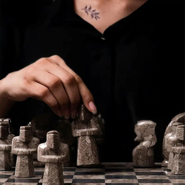 Hand moving oceanic marble rook tower piece — oceanic and black antique medieval figurative chess pieces close-up by RADICALn