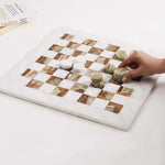 Hand placing green marble checkers disc mid-game — white and green marble checkers set 15 inch with books by RADICALn