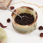 Close-up of the marble salt cellar with spoon, highlighting the marble's fine craftsmanship