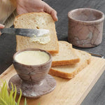 Radicaln marinara marble butter keeper holding soft butter while a slice of toast is buttered