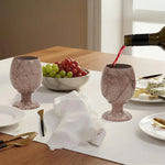 Red wine poured into a marinara marble wine glass at a set dinner table