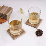 Natural brown square marble coasters under two whiskey glasses on a white table