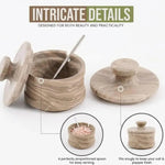 Natural brown marble salt cellar with lid off and spoon inside, showing the snug-fitting notched lid and proportioned serving spoon