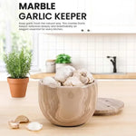 Natural brown marble garlic keeper filled with garlic on a kitchen counter, vented lid beside it