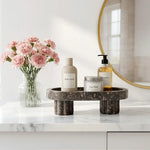 Oceanic footed marble tray holding pump bottles as bathroom storage by a sink
