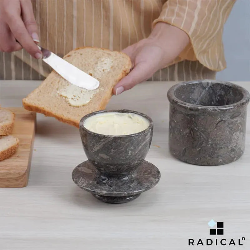 Radicaln oceanic marble butter keeper holding soft butter while a slice of toast is buttered