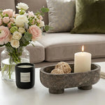 Oceanic marble footed bowl as a living room centerpiece with a candle and flowers