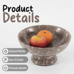 Oceanic marble pedestal fruit bowl holding apples and grapes, showing the natural stone and polished finish