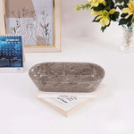 Oceanic marble oval tray on a desk with books, a calendar and flowers