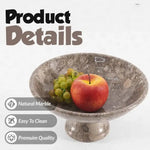 Oceanic marble pedestal fruit bowl with an apple and grapes, showing the natural stone and polished finish