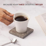 Oceanic square marble coaster under a white coffee cup beside an open book