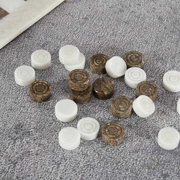 Oceanic and white marble checkers discs scattered on grey textured surface — concentric ring and felt bottom detail by RADICALn