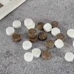 Oceanic and white marble checkers discs scattered on grey textured surface — concentric ring and felt bottom detail by RADICALn
