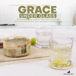 Round green onyx marble coaster set and holder beside drinking glasses on a kitchen counter