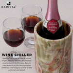 Handmade round green onyx marble wine cooler chilling a bottle beside two filled glasses