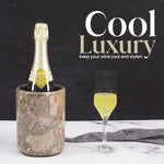 Round oceanic marble wine chiller keeping a champagne bottle cool beside a filled flute
