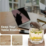 Square natural brown coaster under an iced drink protecting a wooden desk from water stains