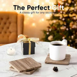 Square natural brown coasters on a marble table with a gift box and Christmas tree lights