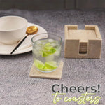 Square travertine coaster set and holder on a grey table with an iced lime drink