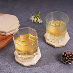 Verona octagon marble coasters under two whiskey glasses on a white table