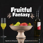 Verona marble footed fruit bowl on a pedestal base holding fruit, styled with a wine bottle and glass