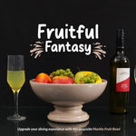 Verona marble pedestal fruit bowl holding fruit as a dining centerpiece, styled with a wine bottle and glass