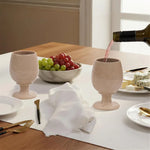 Red wine poured into a verona marble wine glass at a set dinner table