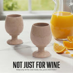 Pair of verona marble wine glasses beside an orange juice pitcher for any cold drink