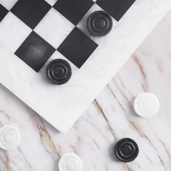 White and black marble checkers set 15 inch — board corner detail with black and white marble disc pieces on marble surface by RADICALn