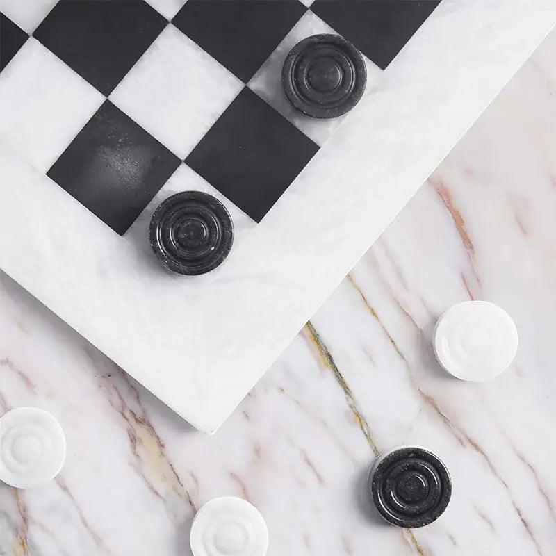 White and black marble checkers set 15 inch — board corner detail with black and white marble disc pieces on marble surface by RADICALn