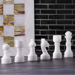 White marble chess pieces lineup — pawn bishop knight rook king queen with green onyx board edge by RADICALn