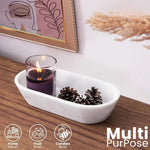 White marble dough bowl as multi-purpose decor holding a candle and pinecones