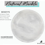 Overhead view of the polished interior of a handmade white marble fruit bowl showing the natural veining