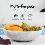 White marble fruit bowl filled with mango, pear and grapes on a kitchen counter, also suited to vegetables, candies or cookies