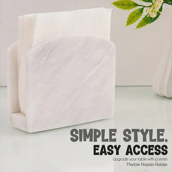 White marble napkin holder filled with white napkins on a styled countertop