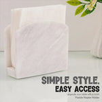 White marble napkin holder filled with white napkins on a styled countertop