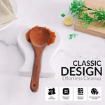 White marble spoon rest holding a wooden ladle on a countertop
