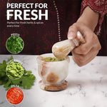 White onyx marble mortar and pestle used to grind fresh herbs for pesto, guacamole and salsa