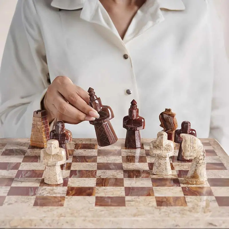 Woman lifting red marble antique bishop figure — coral and red antique marble chess set 15 inch medieval figurative pieces by RADICALn